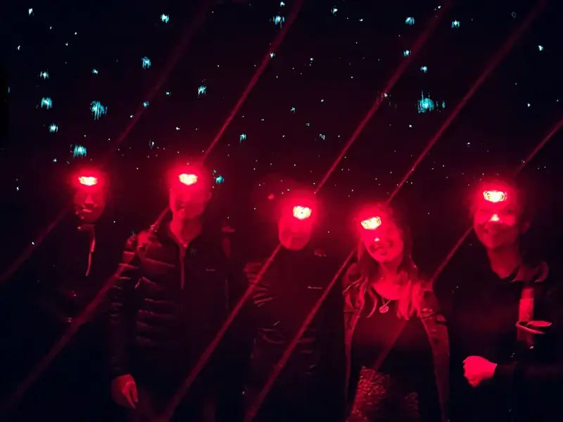 Group wearing red-mode headlamps