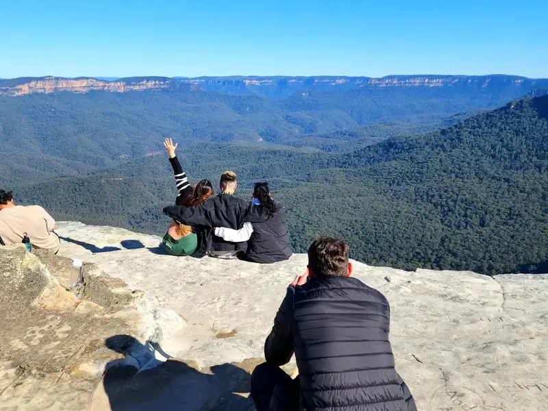 Visitors photographing a sandstone viewpoint — historical listing photo