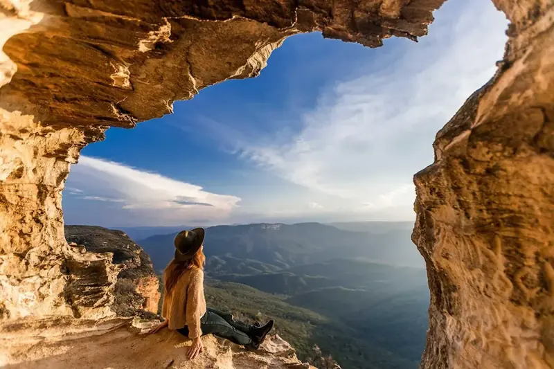 Sandstone overhang framing valley scenery — historical listing photo