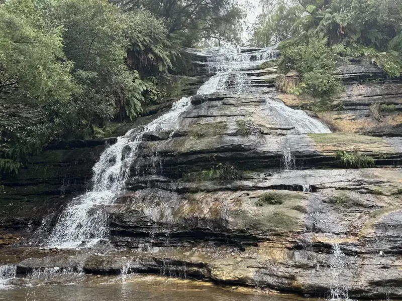 Water cascading over broad sandstone steps